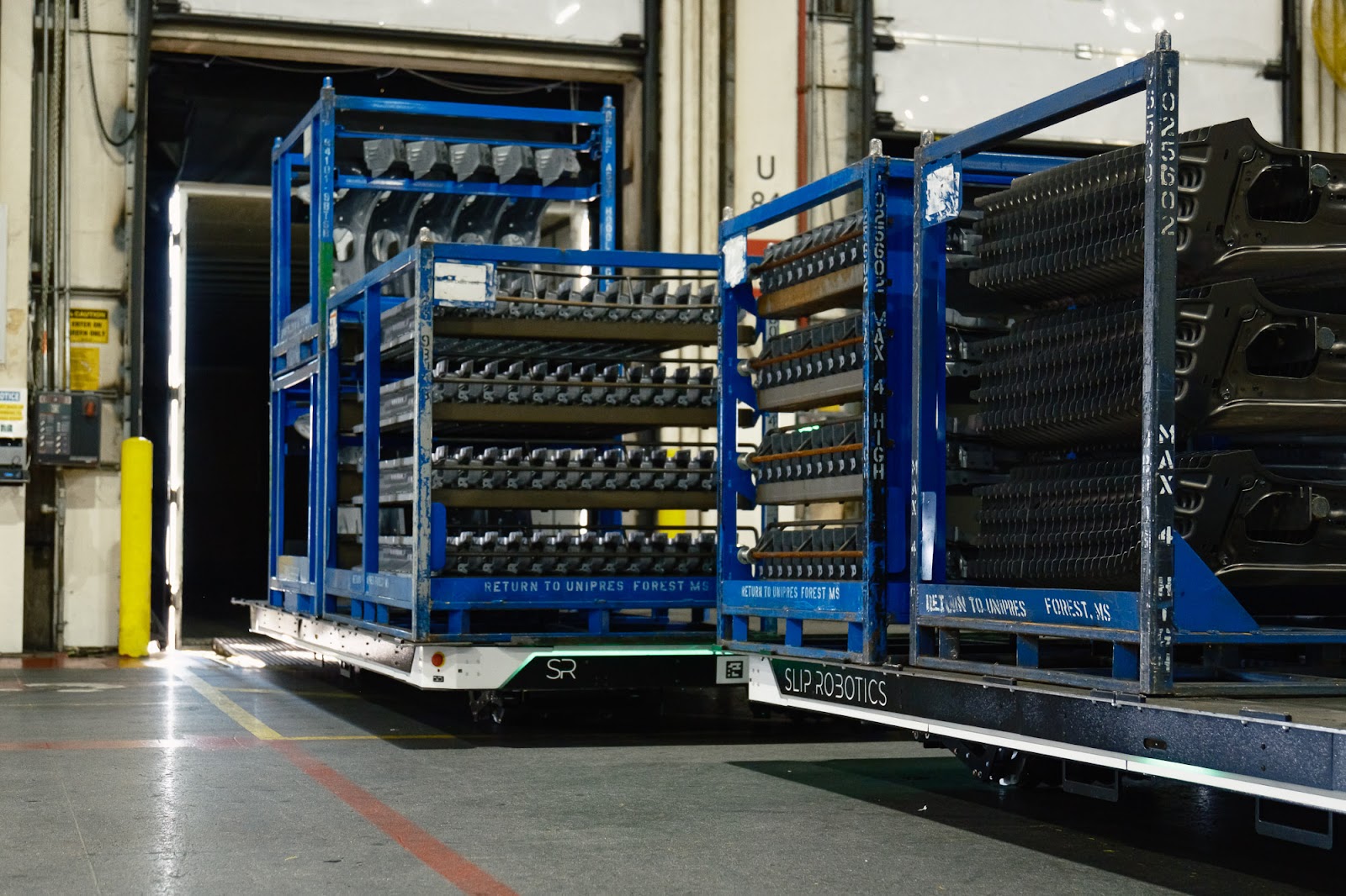 Two Slip Robotics SlipBots carrying loads.