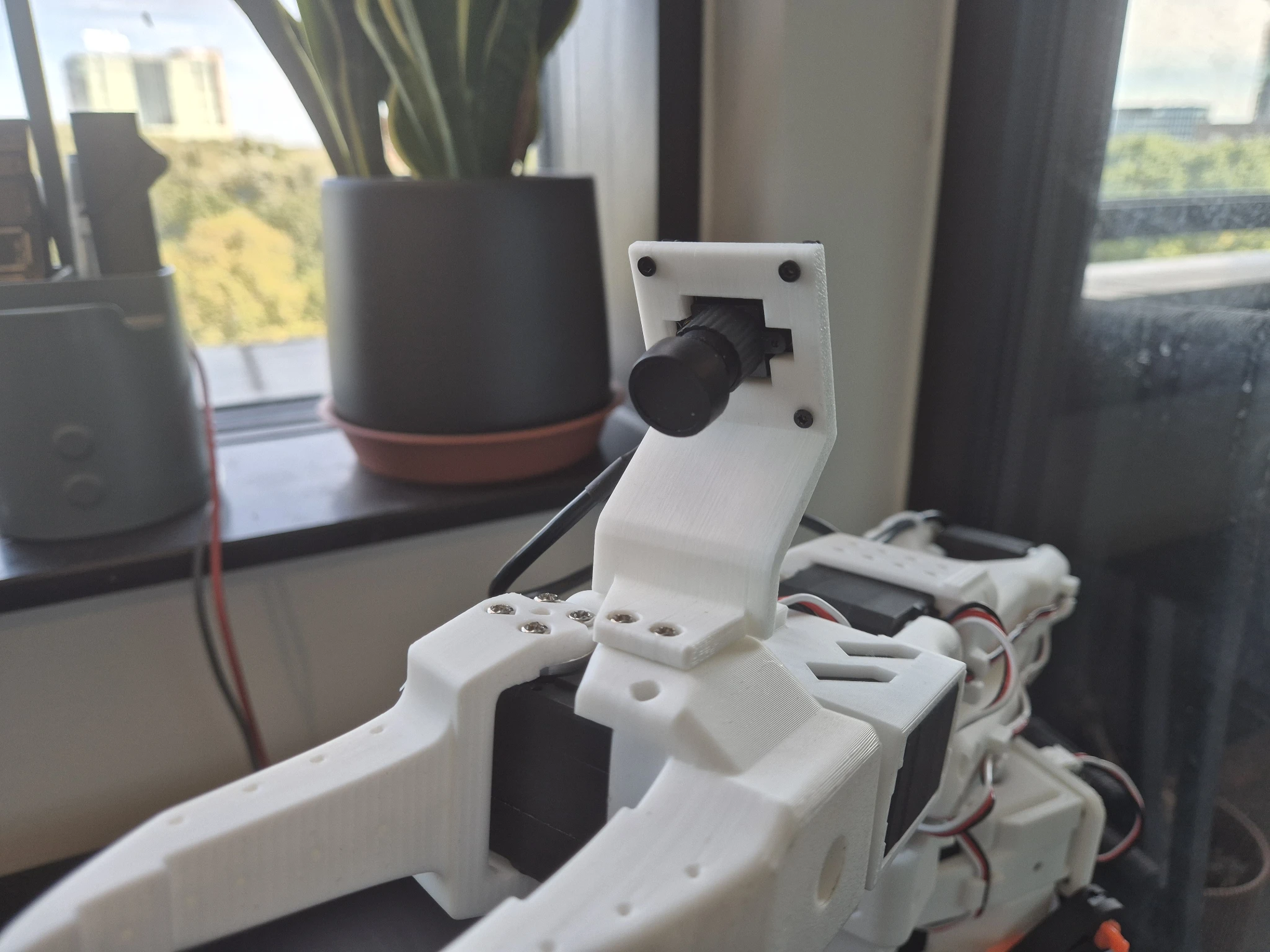 Close-up of the SO-101 wrist camera mount with the camera module attached